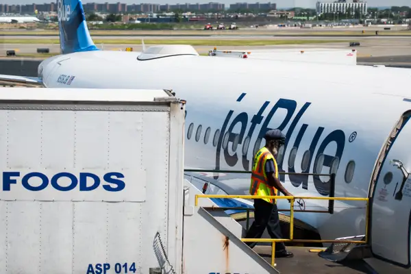 A JetBlue plane being catered,