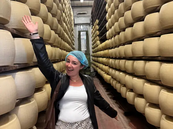 A woman standing at a Parmeggiano Reggiano factory in Parma, Italy.
