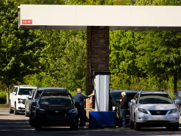 Customers fill their vehicles with gas at a Costco gas station in Tennessee.